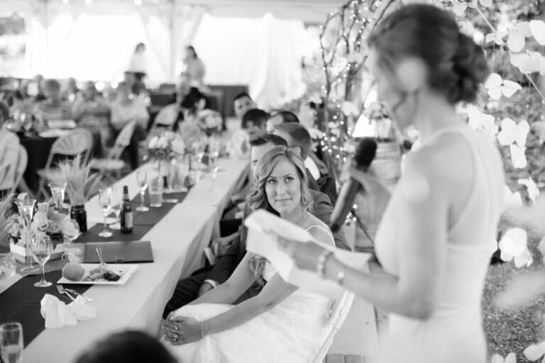 bride looking at maid of honor during maid of honor speech
