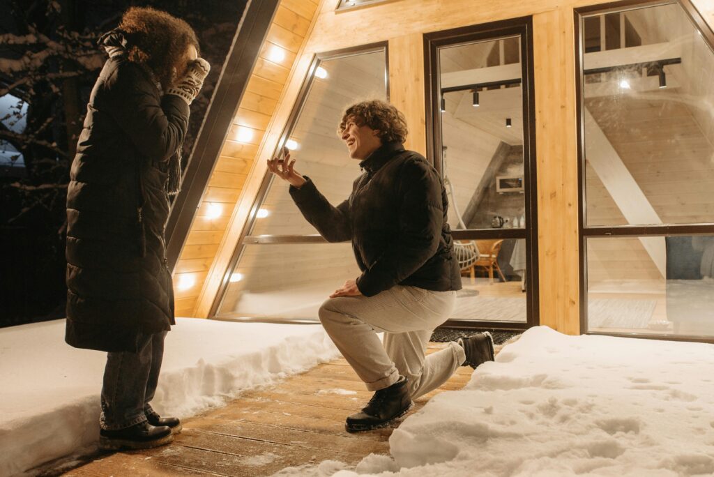 excited couple during a winter proposal in the snow